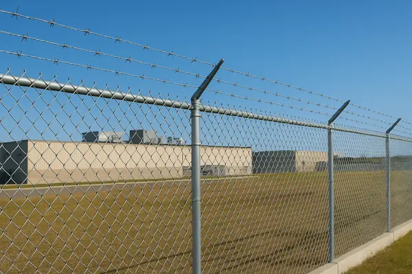 a commercial bulding surrounded by a chained fence from Dallas Fence Company in Dallas, TX - Dog fence installation a commercial bulding surrounded by a chained fence from Dallas Fence Company in Dallas, TX - Dog fence installation